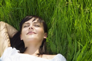 beautiful girl lying down of grass. Copy space